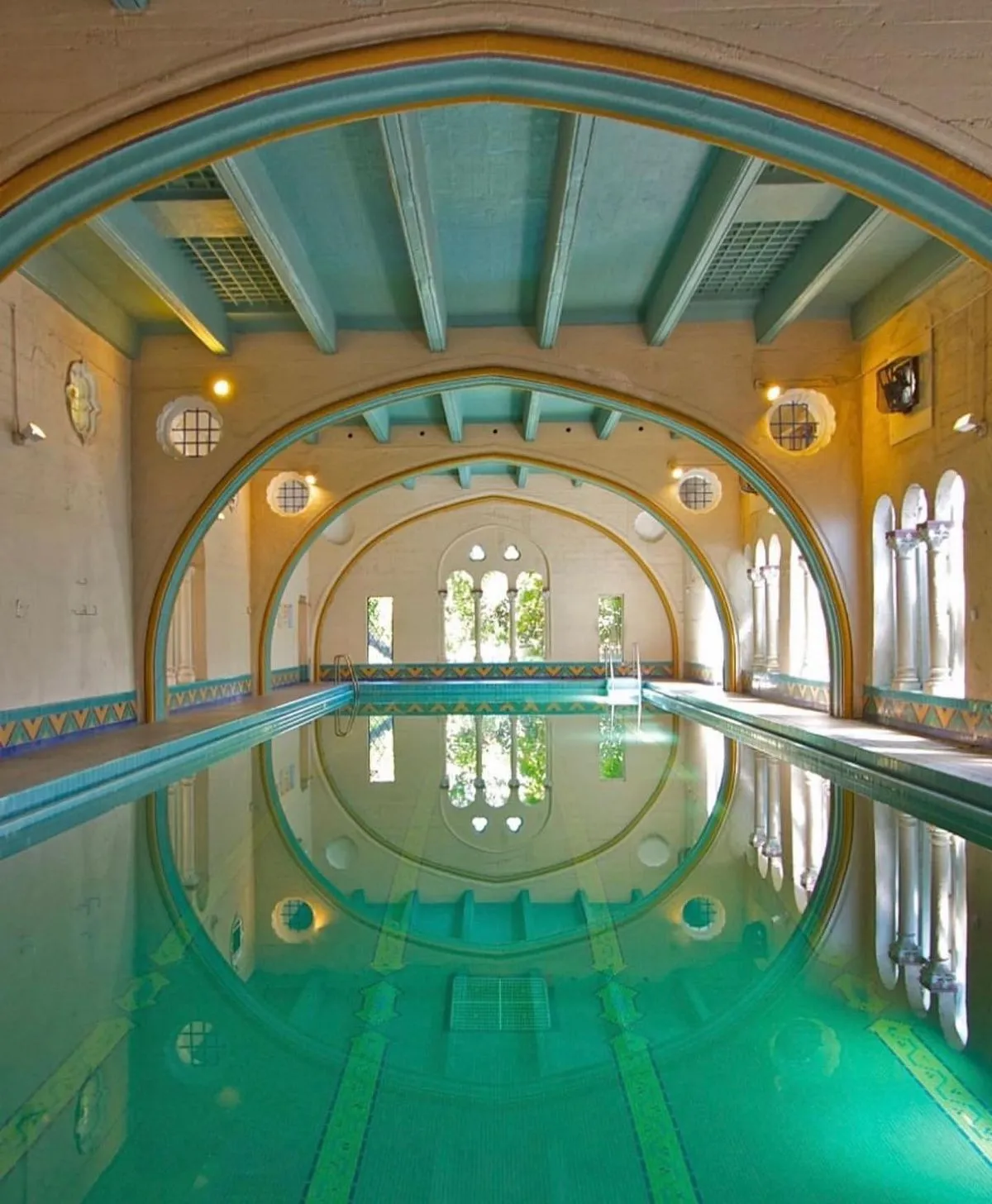 Arched stone doorways and vaulted ceilings inside the historic Berkeley City Club by Julia Morgan