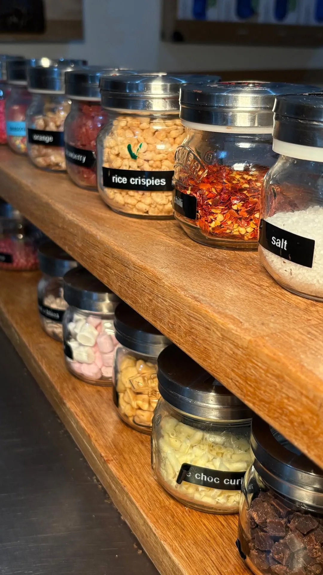 Glass bowls of chocolate toppings for custom bar making