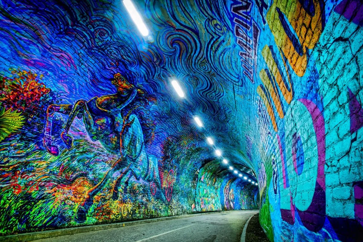 Brightly colored murals lining the brick walls of the Colinton Tunnel in Edinburgh
