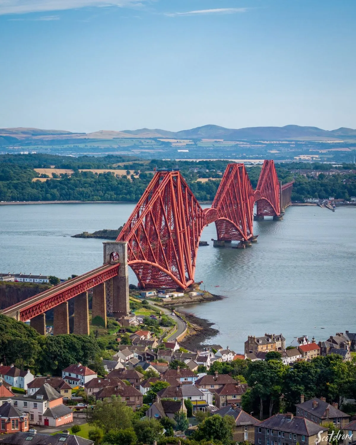 A view of the historic red Forth Bridge from a train window on the way to Fife