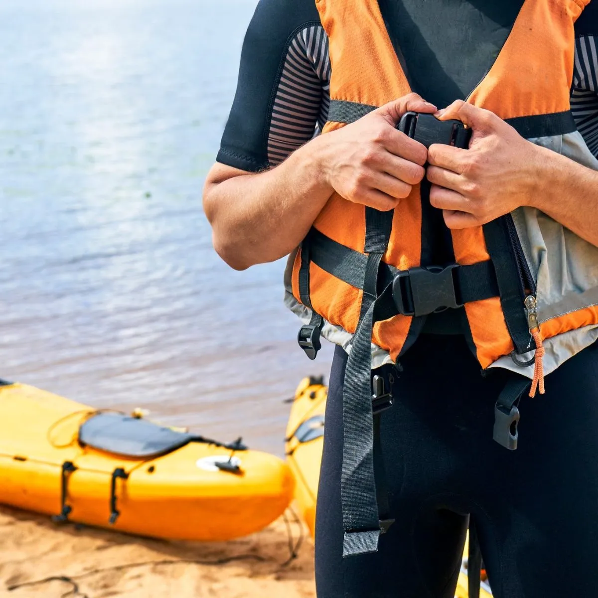 A life jacket and paddle prepared for a kayaking trip