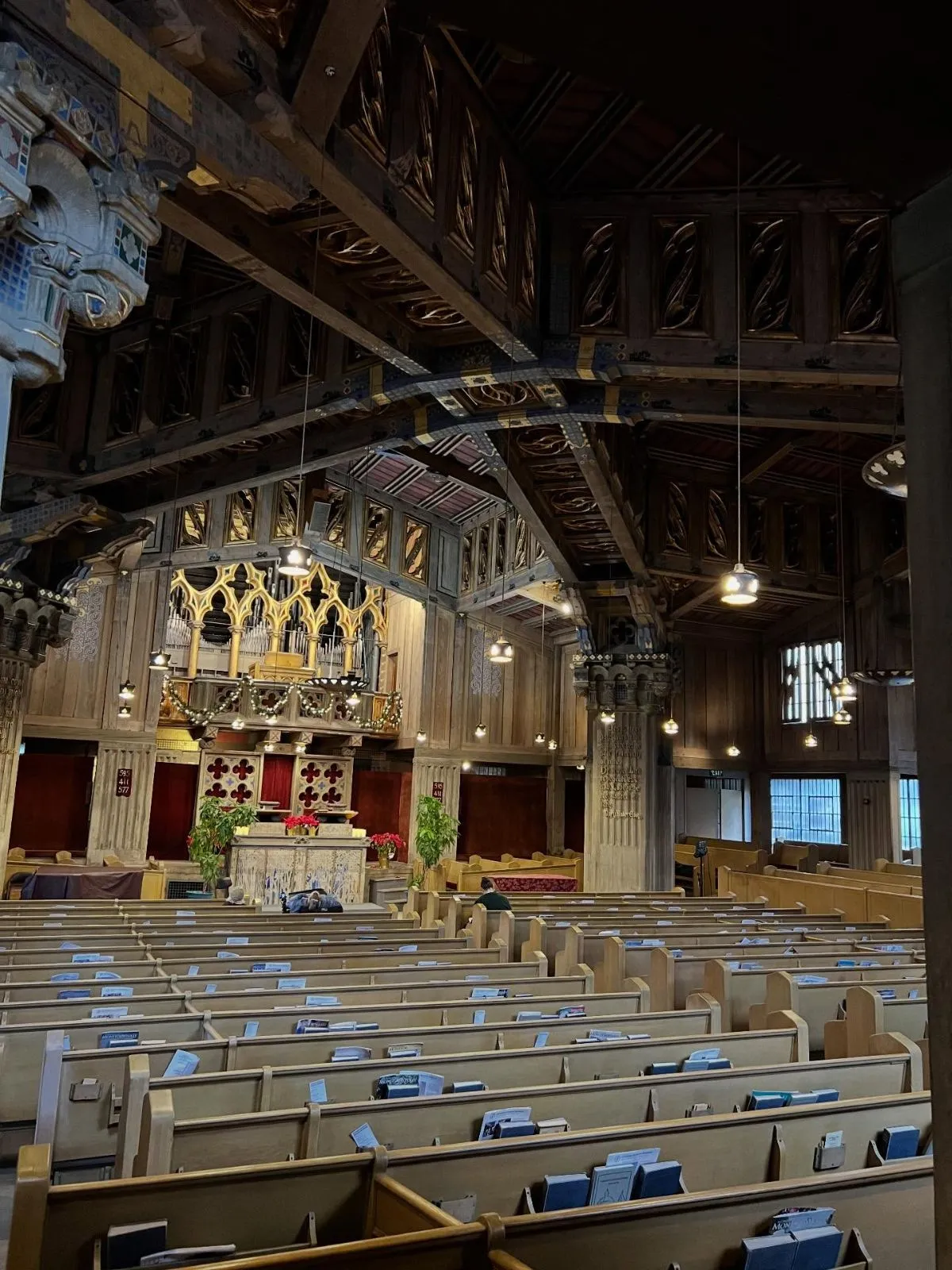 Exterior view of the First Church of Christ Scientist in Berkeley featuring wood carvings and vines