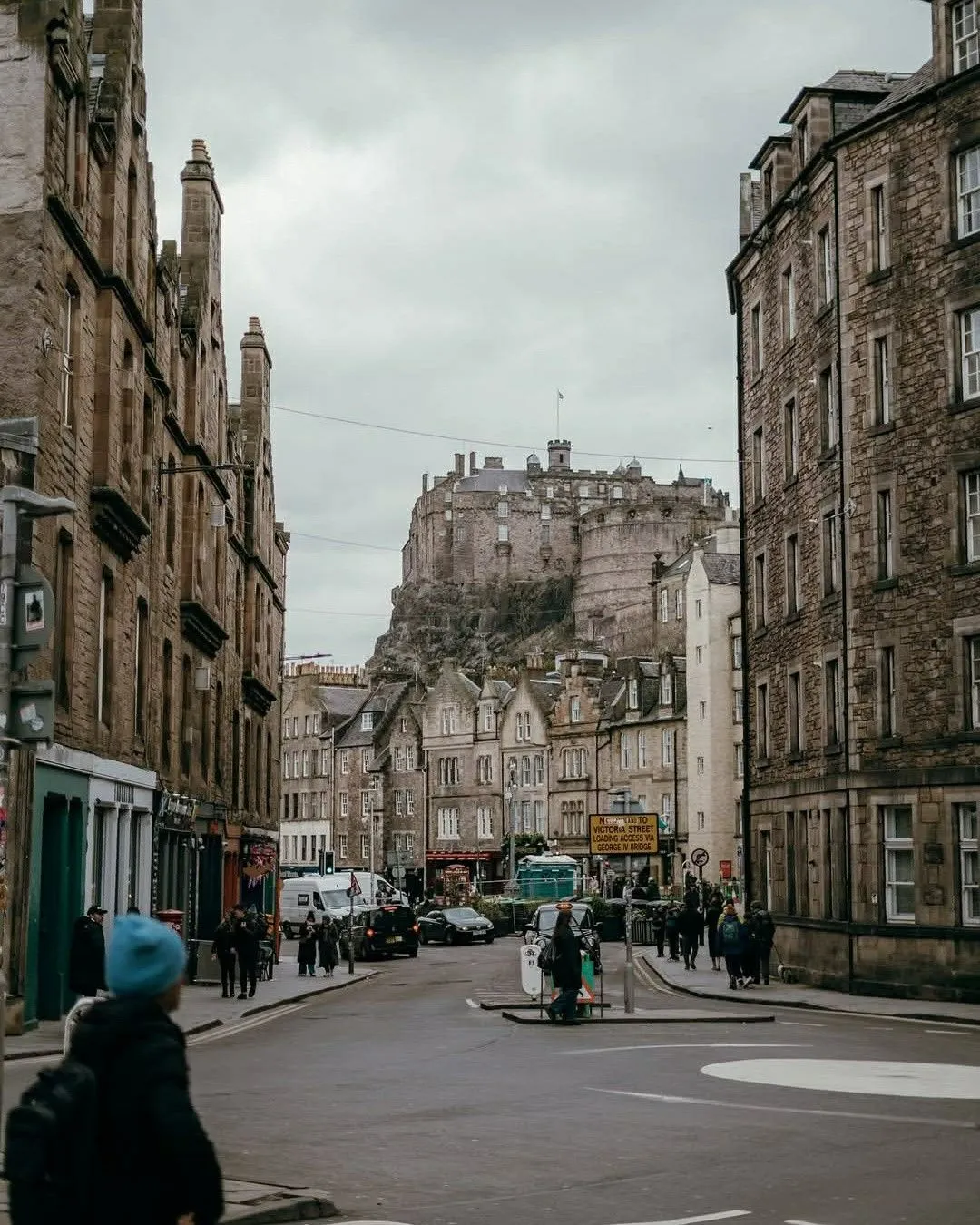 Historic cobblestone streets of the Grassmarket district in Edinburgh below the castle