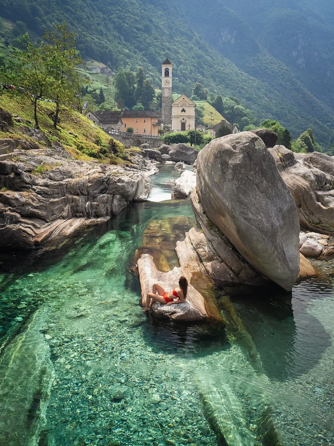 Emerald waters flowing through smooth carved rocks in Lavertezzo Canyon