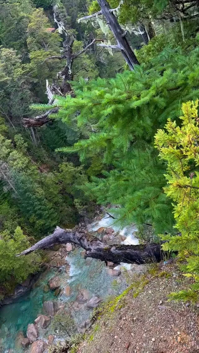 Hiker carefully crossing a shallow mountain stream near Refugio Motoco