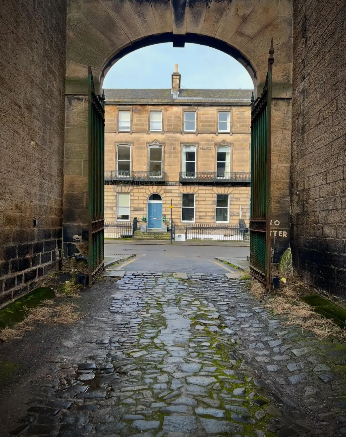 Atmospheric stone archway reflecting the history of Tweeddale Court