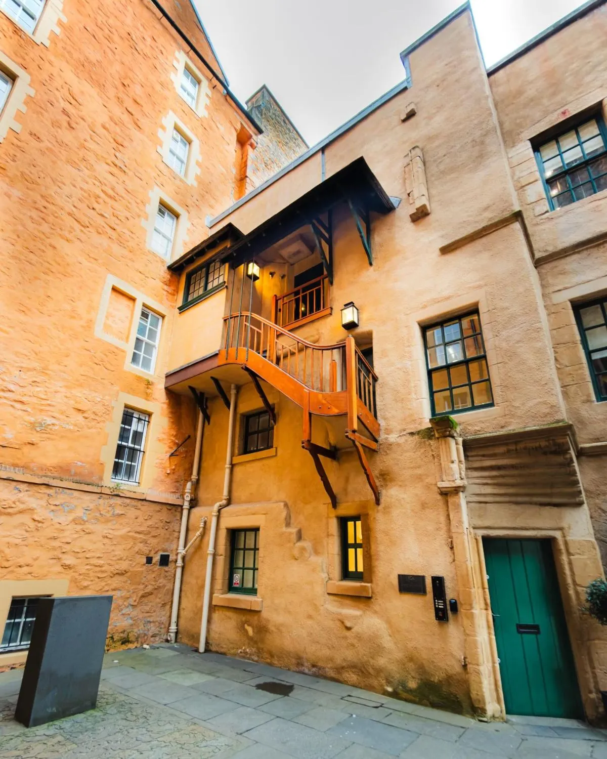 Stone archway leading to the historic Renaissance courtyard of Riddles Court in Edinburgh