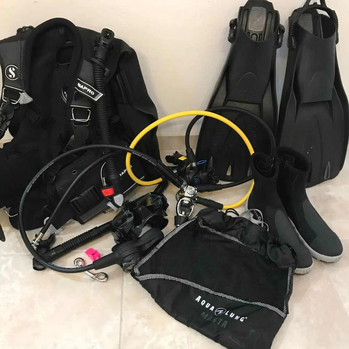 Scuba diving gear on rocks near emerald river