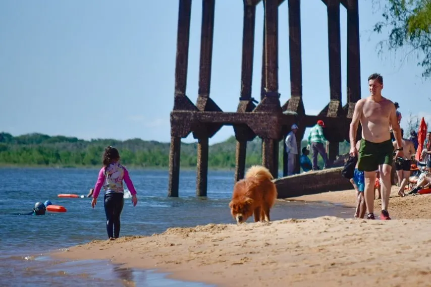 Clear river water and swimming essentials on golden sand