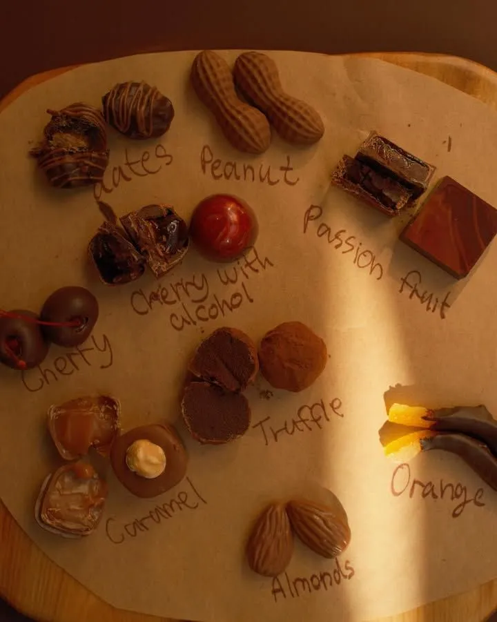 Close-up of premium Scottish chocolate truffles on a rustic wooden tasting board