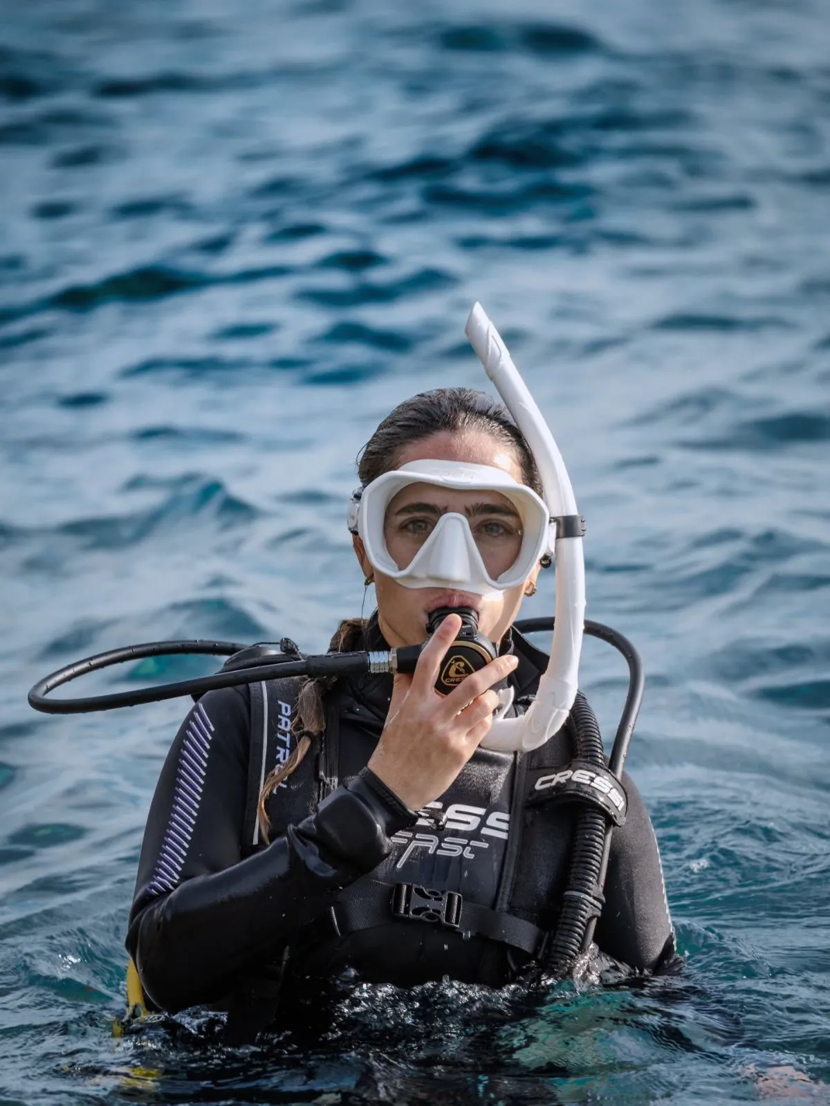 Diver preparing drysuit and scuba gear by the Verzasca River in Switzerland