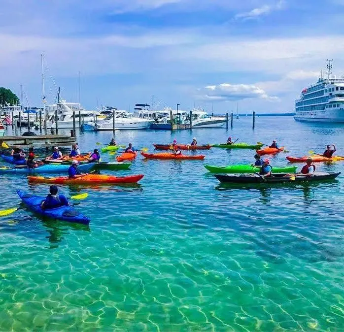 A colorful kayak on clear turquoise water near Mackinac Island