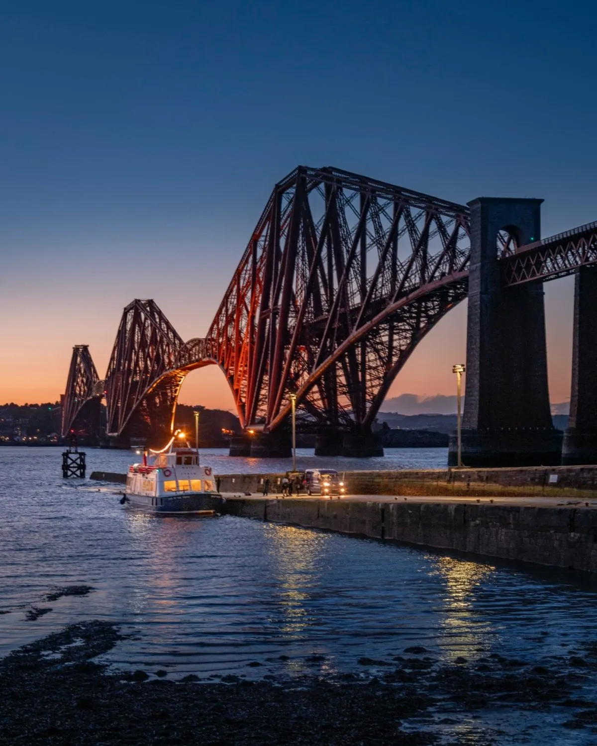Red Forth Bridge seen from cobbled streets of South Queensferry