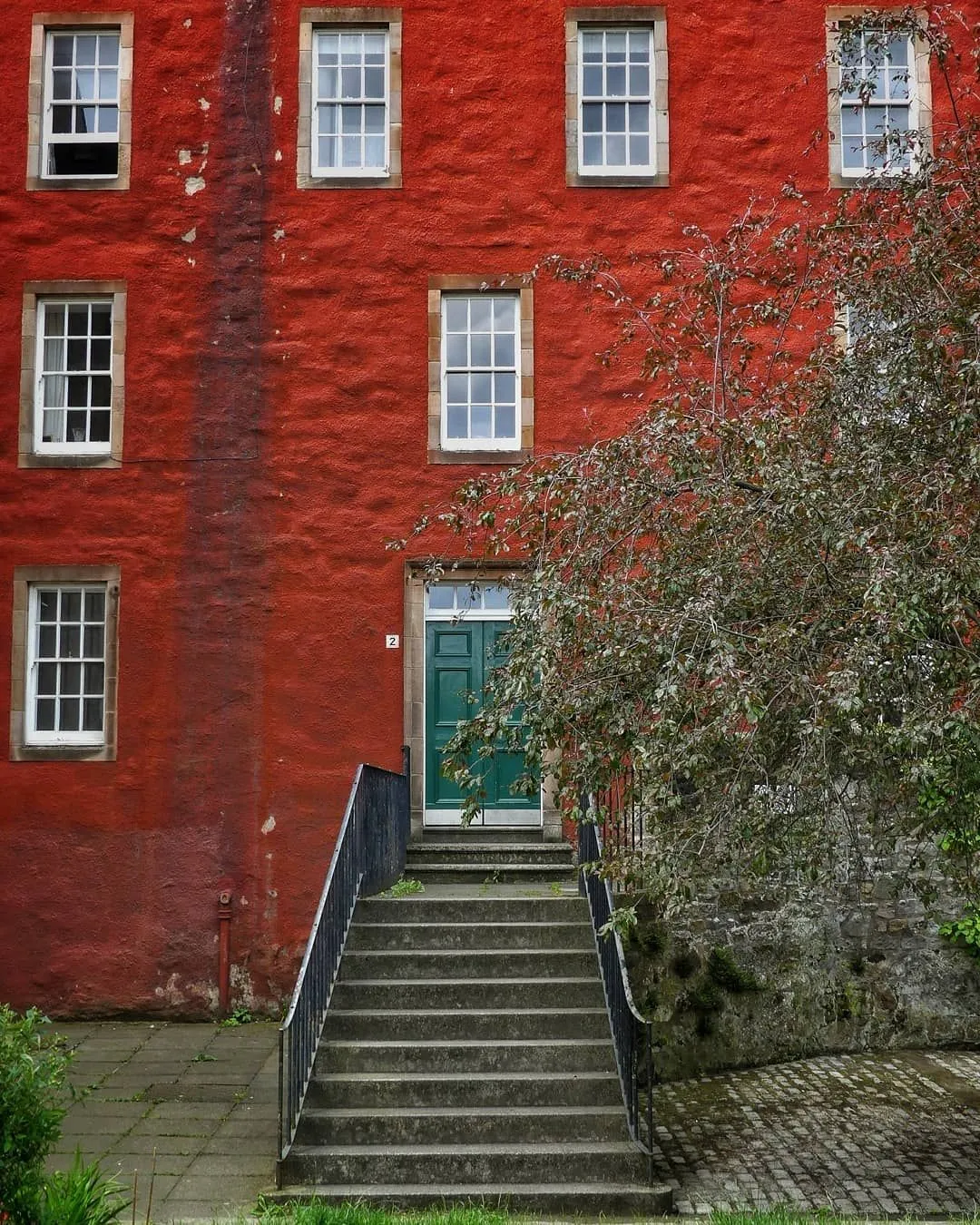 Stone arch entrance leading into Chessels Court in Edinburgh