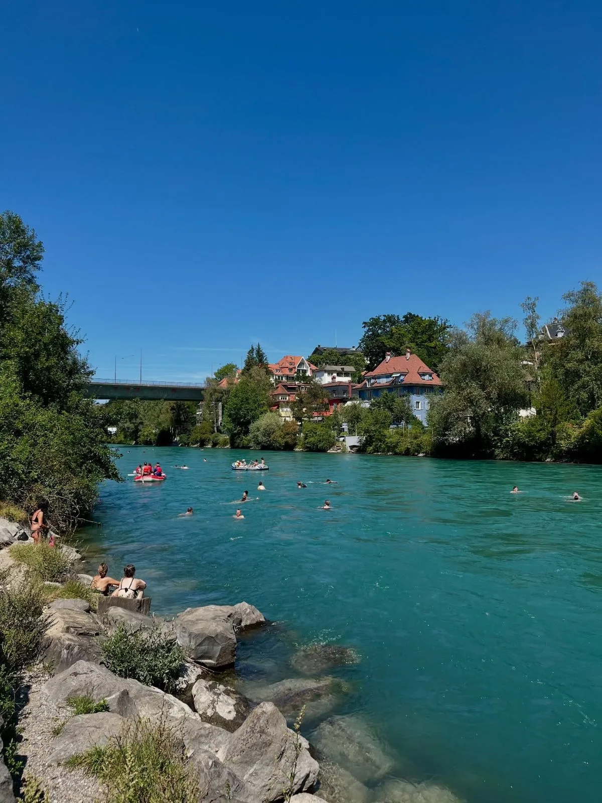 People floating safely down the cold alpine currents of the Aare river in Bern Switzerland