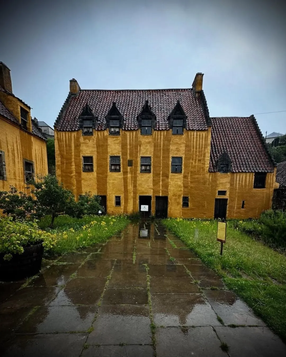 The bright yellow lime-washed exterior of Culross Palace in the village of Culross