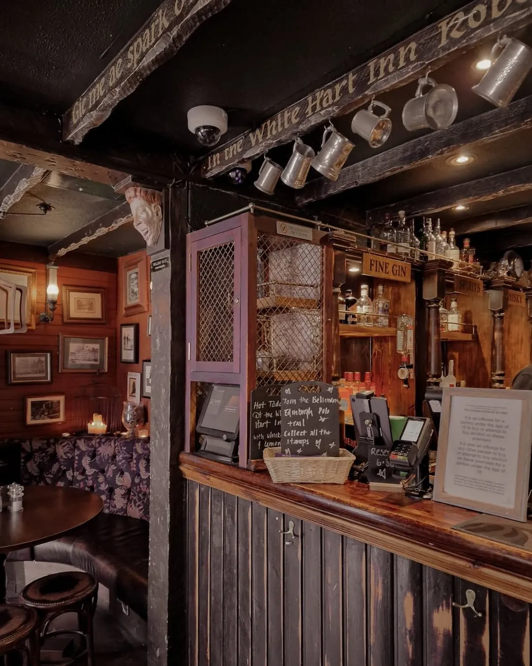 Patrons enjoying a hearty meal inside a traditional wooden Edinburgh pub