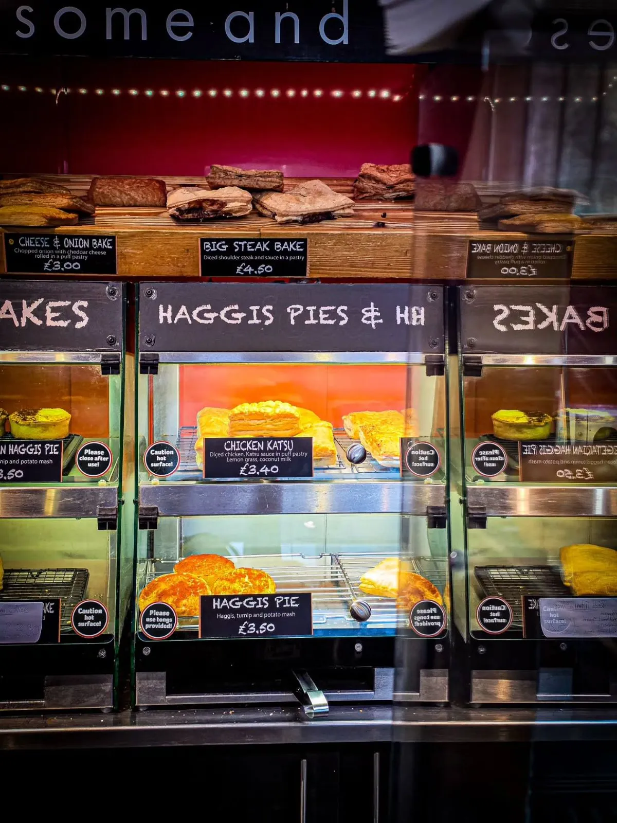 Glass display cabinet filled with an assortment of traditional Scottish savory pies