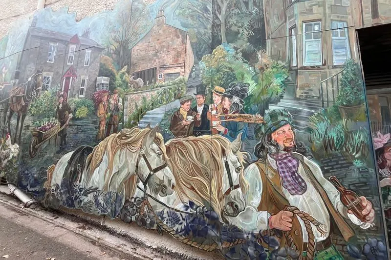 Close up of painted Victorian figures on the brick walls of Colinton Tunnel