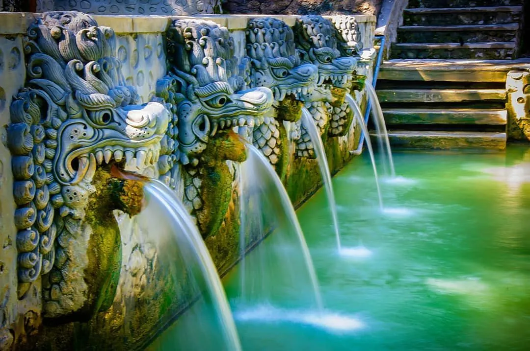 Stone naga pouring water into Banjar Hot Springs