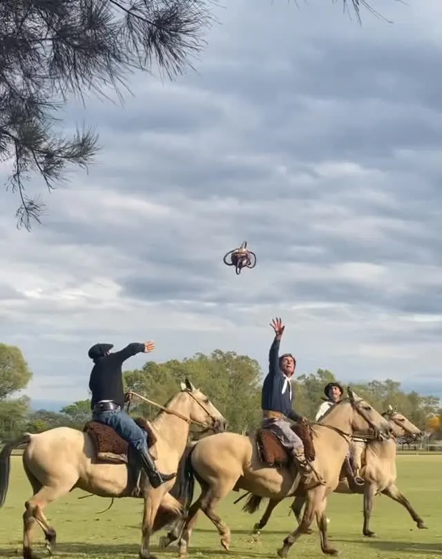 A family riding horses near a traditional Argentine estancia in the Sierras de Córdoba during summer.