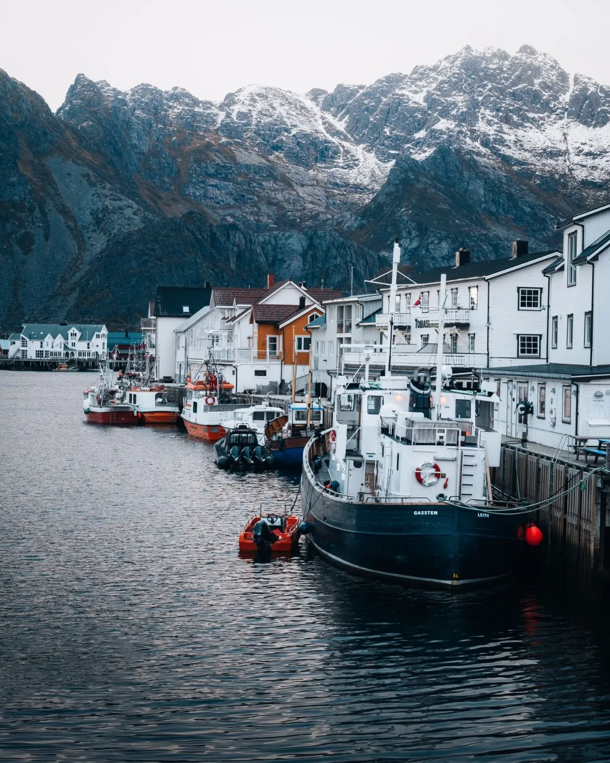 A local passenger ferry arriving at a picturesque Lofoten harbor