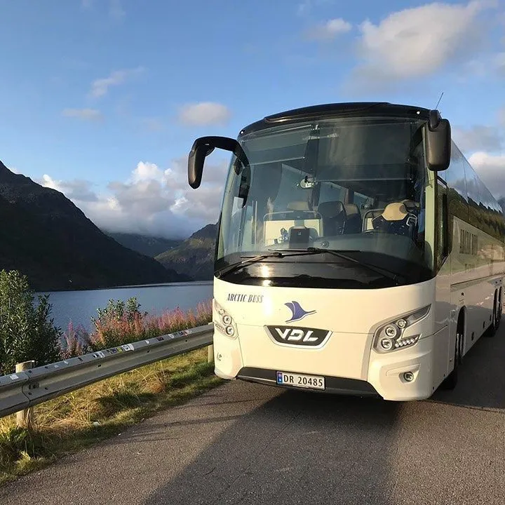 Local bus driving on a coastal road in the Lofoten Islands