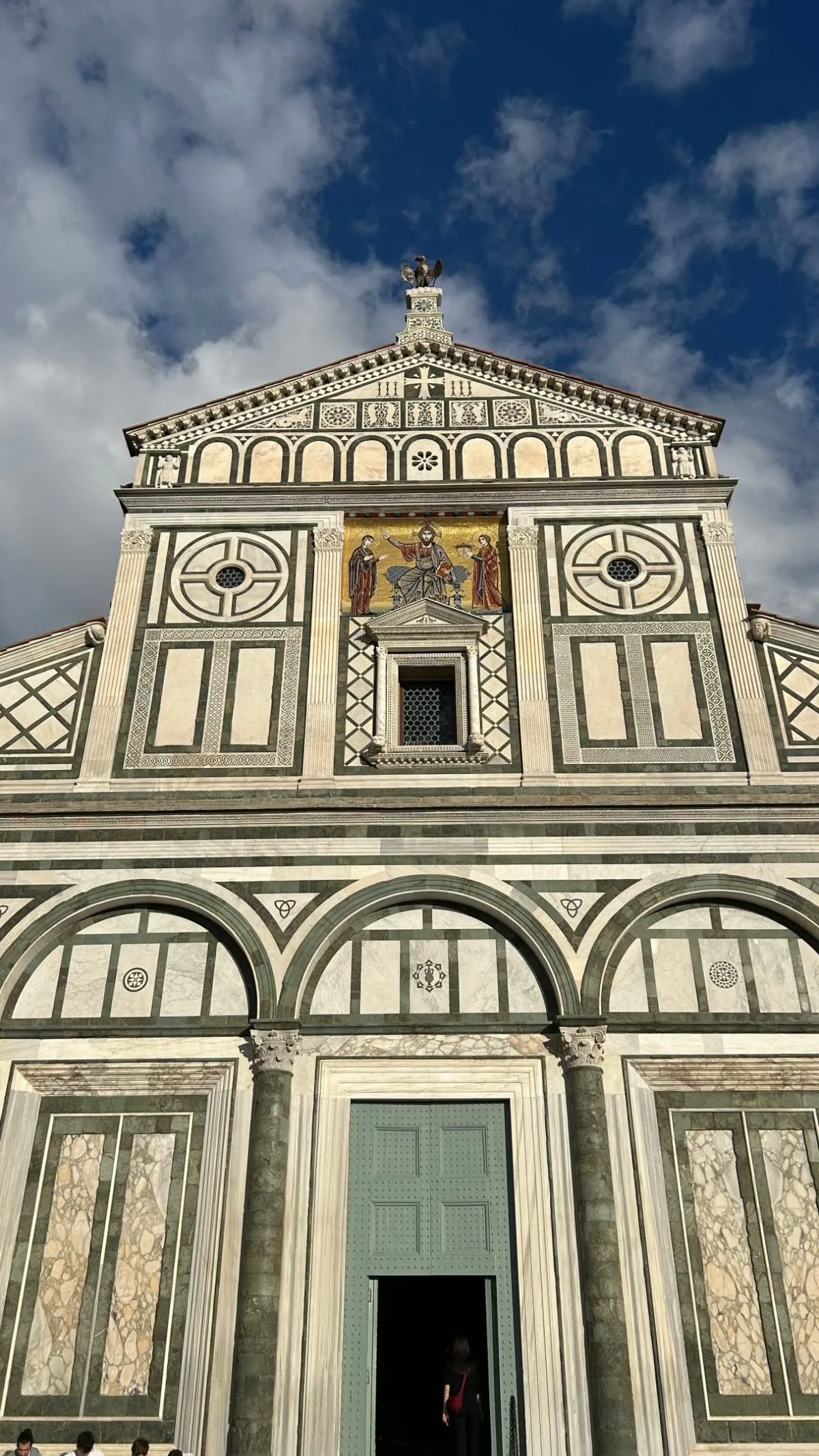 The historic stone exterior of the Basilica of San Lorenzo in Florence, Italy, under a clear blue sky.
